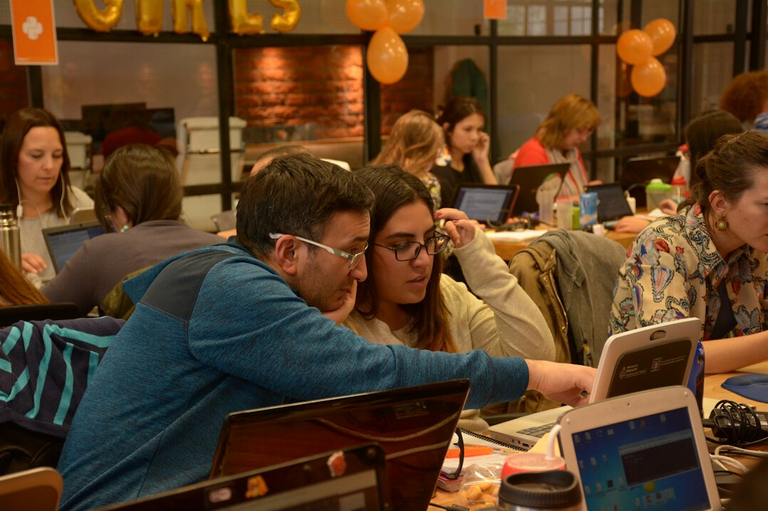 students coding together