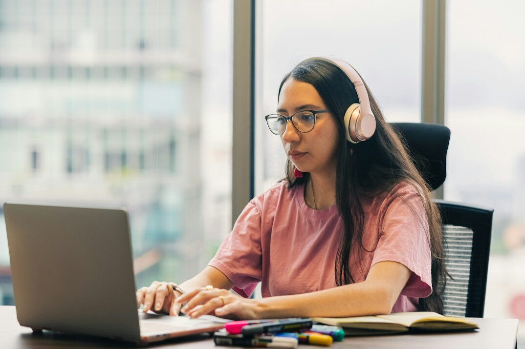 young woman coding at desk