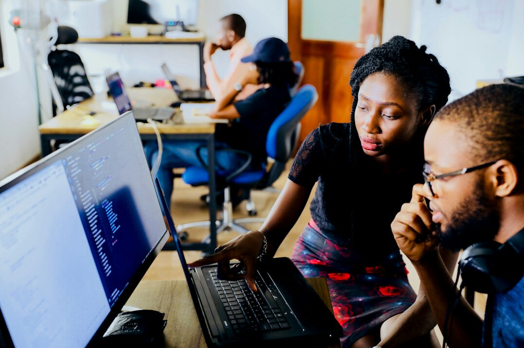 developer reviewing code with colleague