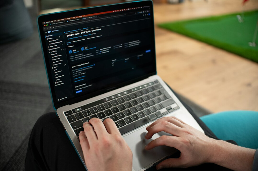 programmer typing code on laptop